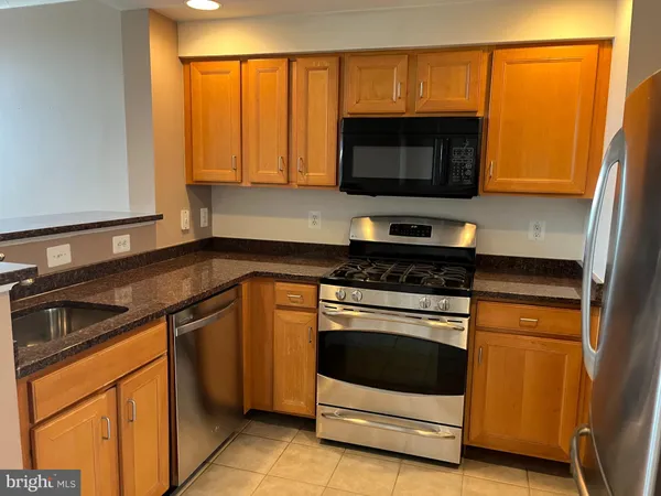 a kitchen with stainless steel appliances a stove and a microwave