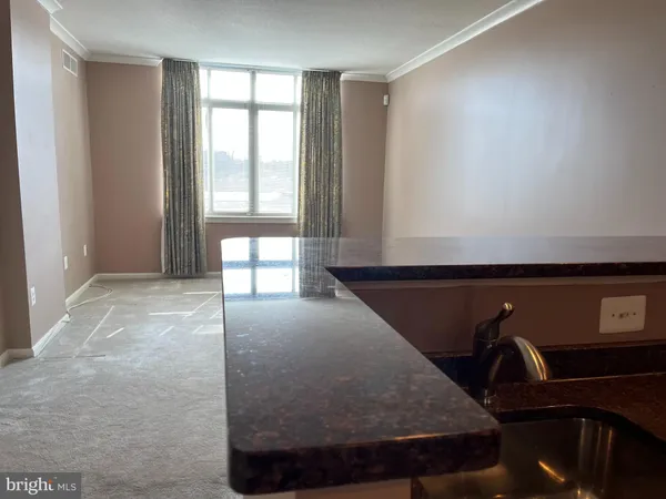 a view of room with window and lounge chair