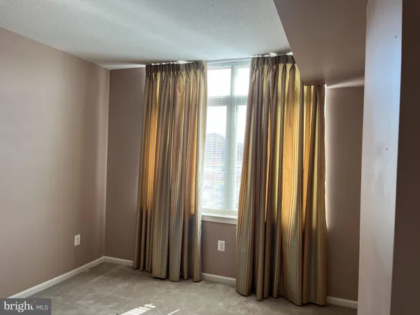 a view of a hallway with bathroom and a bathroom