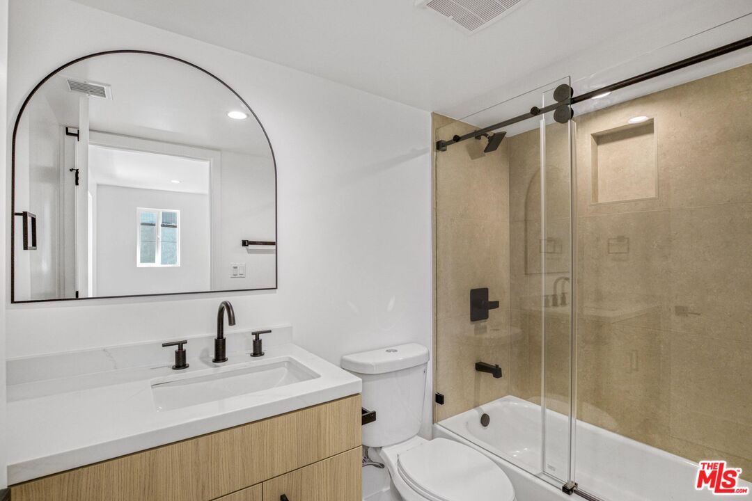 10826 3/4 Hesby Street North Hollywood, CA 91601 - Photo 15 of 26 a bathroom with a sink toilet vanity and shower