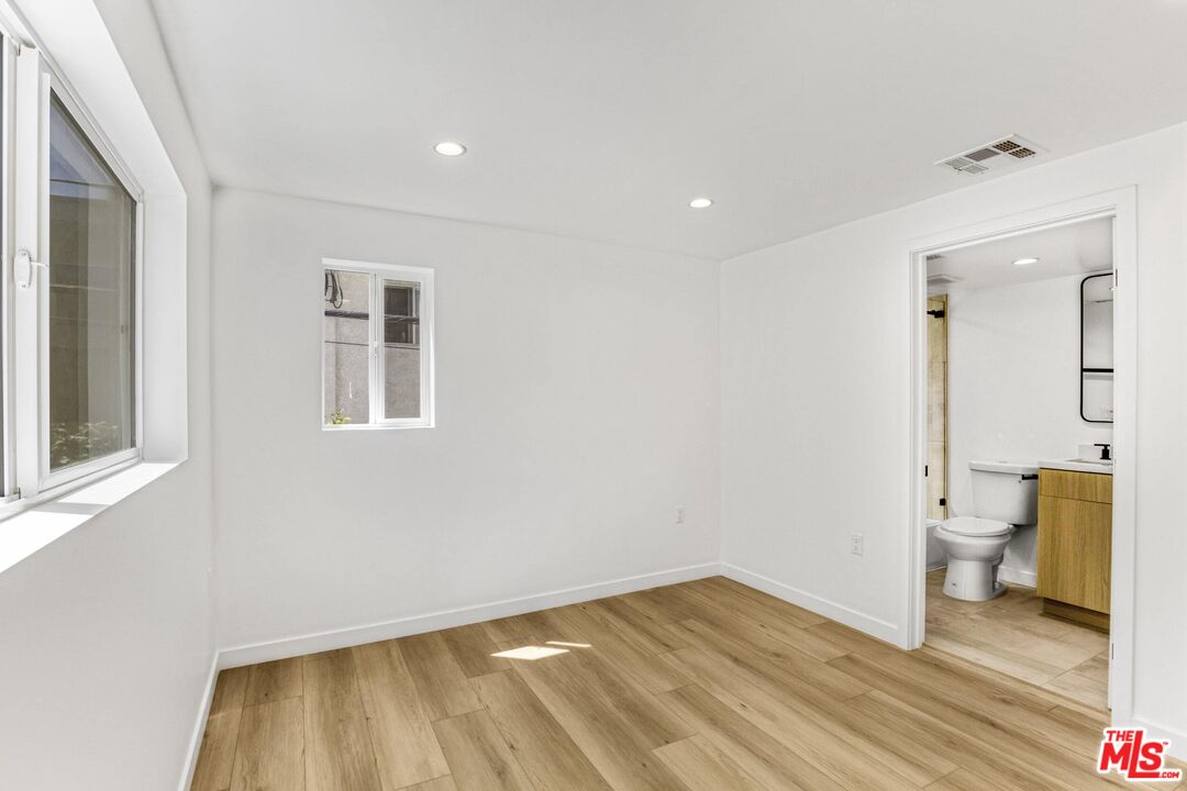 10826 3/4 Hesby Street North Hollywood, CA 91601 - Photo 18 of 26 a view of a room with wooden floor and a bathroom