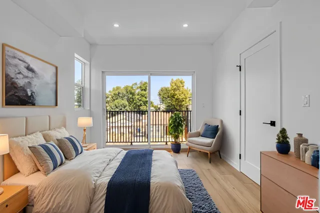 a bedroom with a large bed and a large window