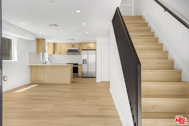 a view of kitchen with cabinets and wooden floor