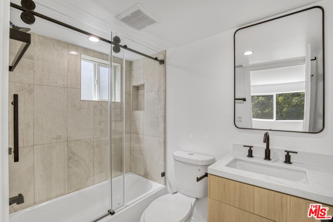 10826 3/4 Hesby Street North Hollywood, CA 91601 - Photo 8 of 26 a bathroom with a granite countertop sink toilet and shower