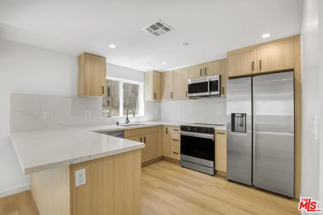 a kitchen with a sink stove and refrigerator