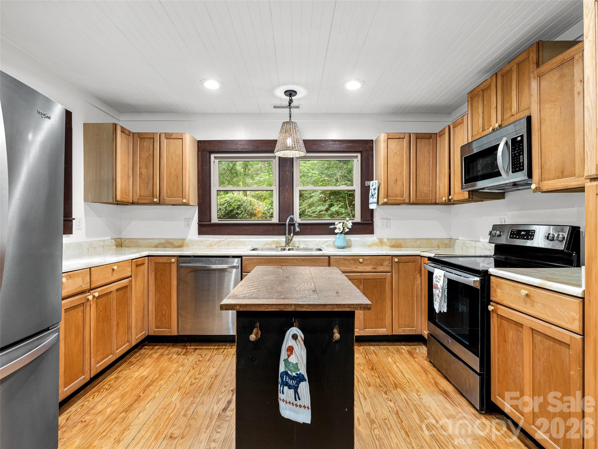 206 Chestnut Hill Road Gerton, NC 28735 - Photo 7 of 48 a kitchen with stainless steel appliances granite countertop a sink a stove a refrigerator cabinets and a window