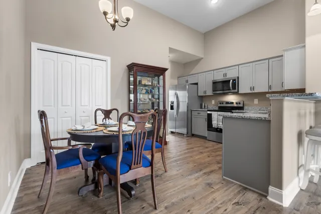 a view of kitchen with refrigerator dining table and chairs