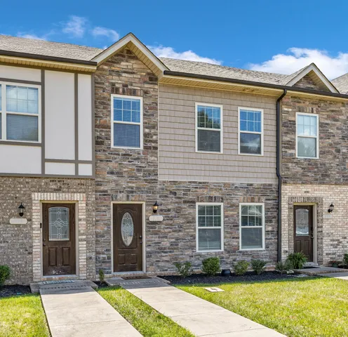 a front view of a house with a yard