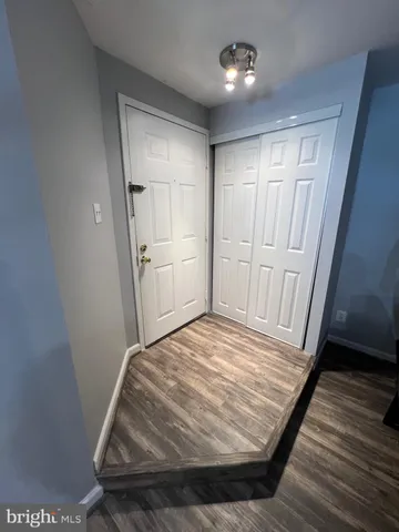 a view of walk in closet with wooden floor