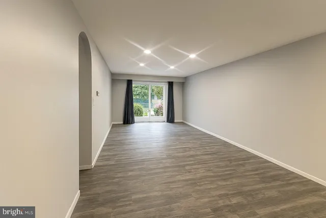 a kitchen with a sink a refrigerator and cabinets