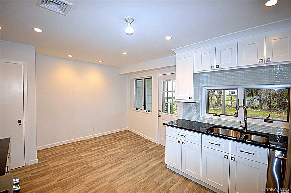 5 Gilbert Road Great Neck, NY 11024 - Photo 11 of 20 a kitchen with granite countertop a sink and cabinets
