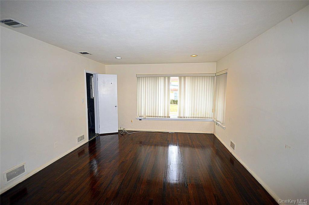 5 Gilbert Road Great Neck, NY 11024 - Photo 13 of 20 a view of an empty room with wooden floor and window