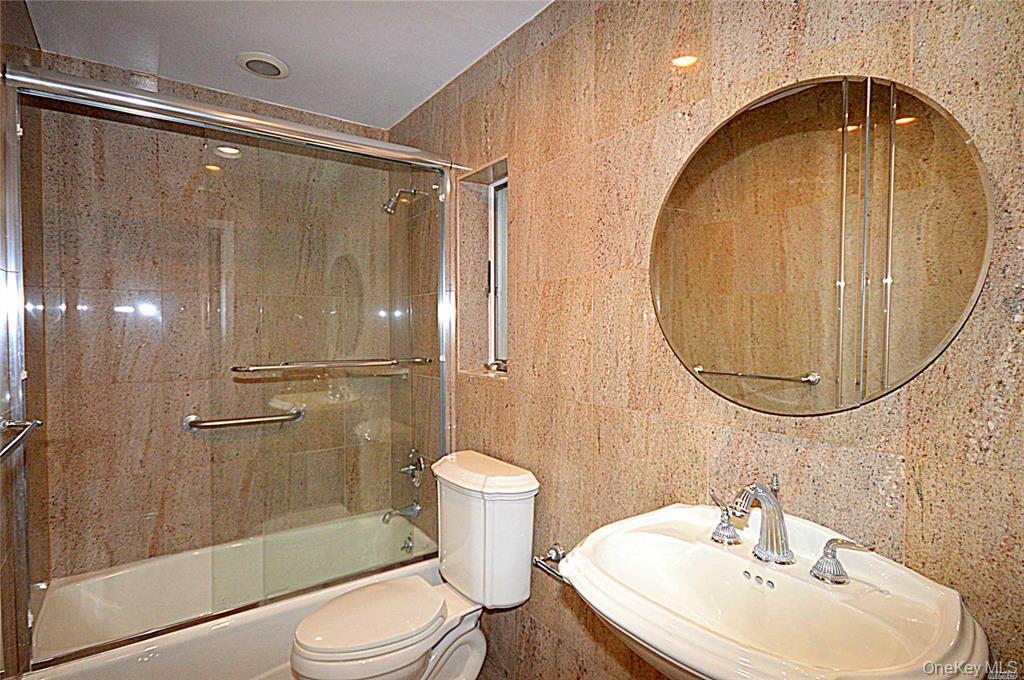 5 Gilbert Road Great Neck, NY 11024 - Photo 16 of 20 a bathroom with a sink toilet and shower