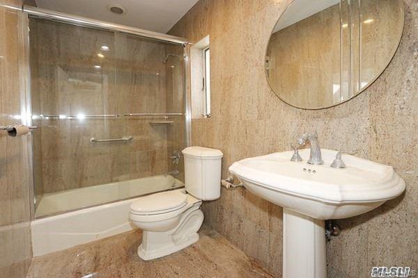 5 Gilbert Road Great Neck, NY 11024 - Photo 17 of 20 a bathroom with a sink toilet and shower