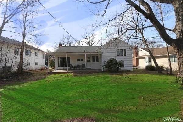 5 Gilbert Road Great Neck, NY 11024 - Photo 19 of 20 a front view of a house with a garden