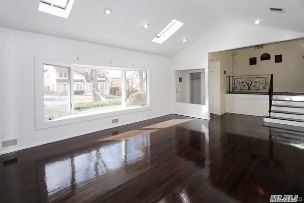 5 Gilbert Road Great Neck, NY 11024 - Photo 4 of 20 a view of an empty room with wooden floor and a window