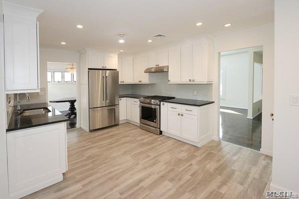 5 Gilbert Road Great Neck, NY 11024 - Photo 10 of 20 a kitchen with a refrigerator a sink and a microwave
