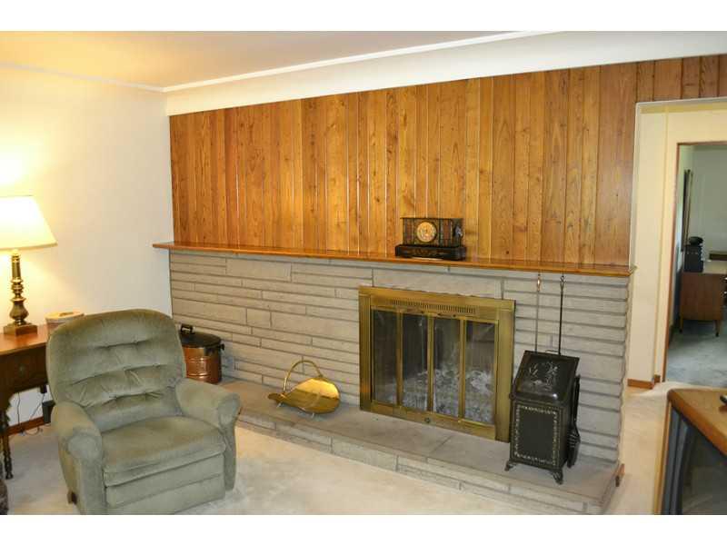 8270 Fox Ridge Road Pittsburgh, PA 15237 - Photo 8 of 25 Living Room. Stone fireplace with wormy chestnut paneling above.