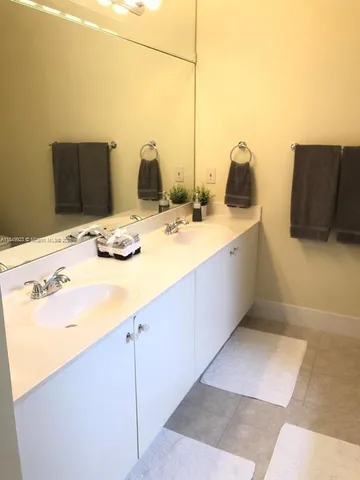 a bathroom with a tub sink and mirror