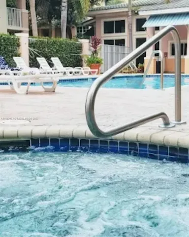 a view of a house with a backyard porch and sitting area