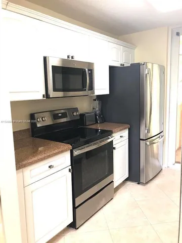 a kitchen with a refrigerator stove and microwave
