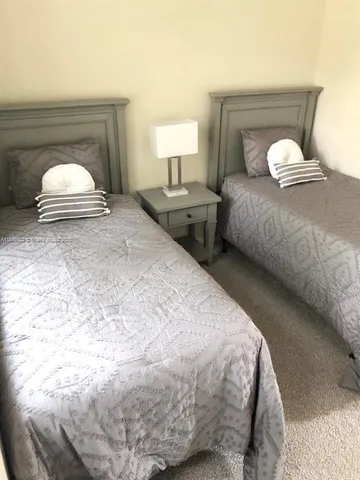 a bedroom with bed and a window