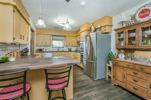 a kitchen with stainless steel appliances granite countertop a sink and cabinets