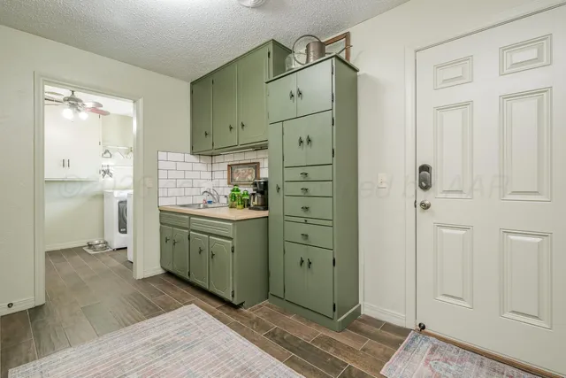 a kitchen with a sink a stove and cabinets