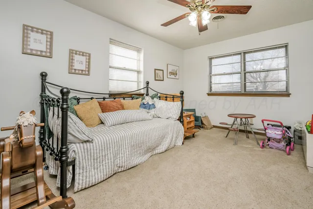 a bathroom with a granite countertop sink toilet and mirror