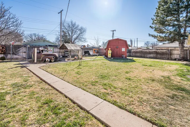 a view of a backyard with table and chairs