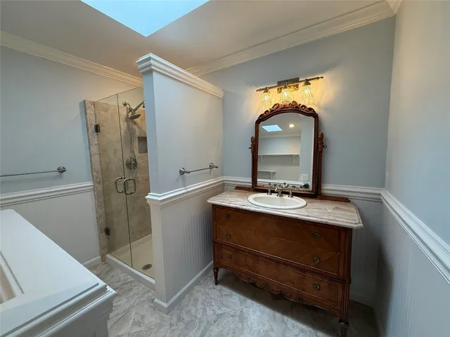 a room with a sink and a mirror