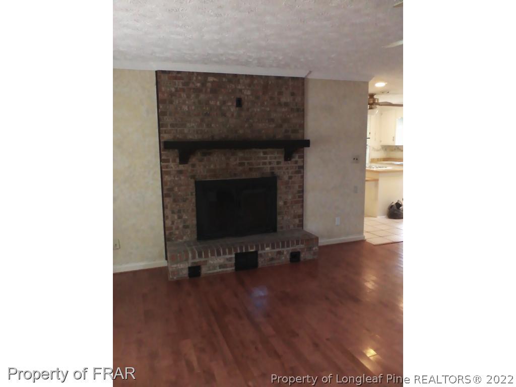 1305 Myra Road Rockfish, NC 28376 - Photo 11 of 17 a living room with furniture and a fireplace