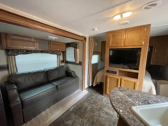 a living room with a flat screen tv and a couch