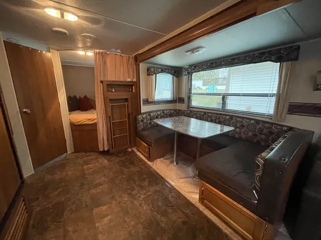 a living room with a table and chairs