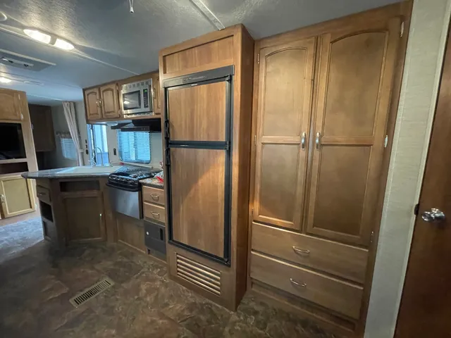 a kitchen with stainless steel appliances a refrigerator and cabinets