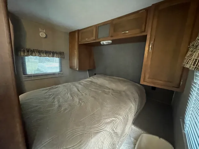 a bed sitting in a room next to a window