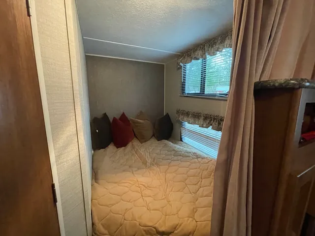 a bed room with a bed and a window