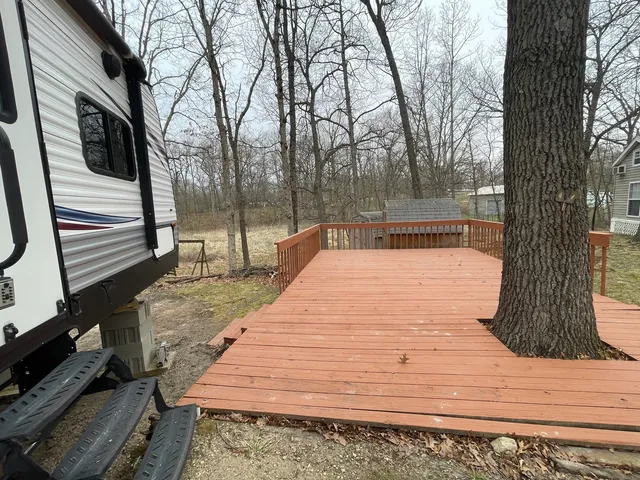 a wooden bench sitting in front of a house