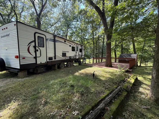 a backyard of a house with barbeque oven table and chairs
