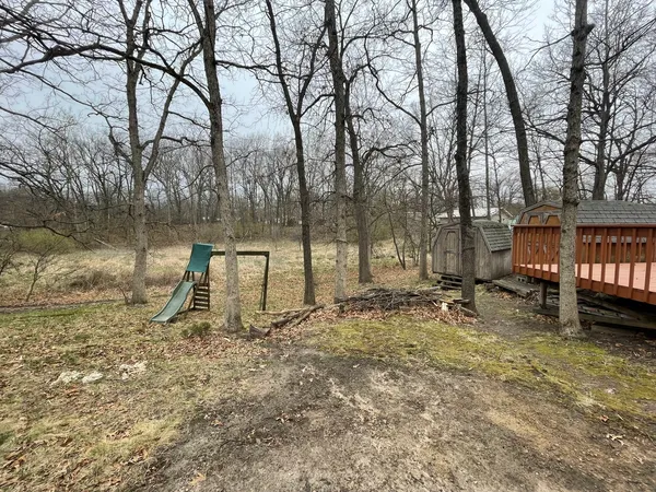 a backyard of a house with lots of green space and fountain