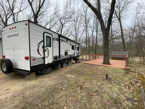 a white house with a large tree in front of it