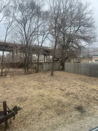 a backyard of a house with a large tree