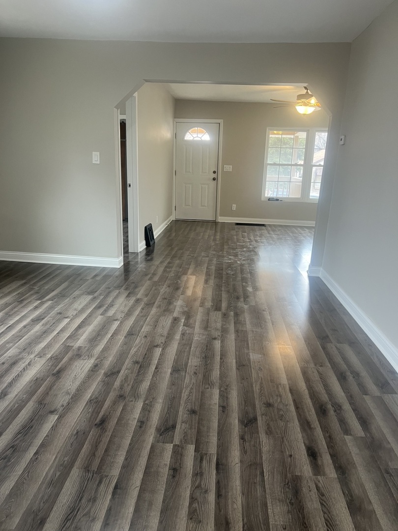 207 Davis Street Joliet, IL 60436 - Photo 7 of 23 a view of an empty room and wooden floor