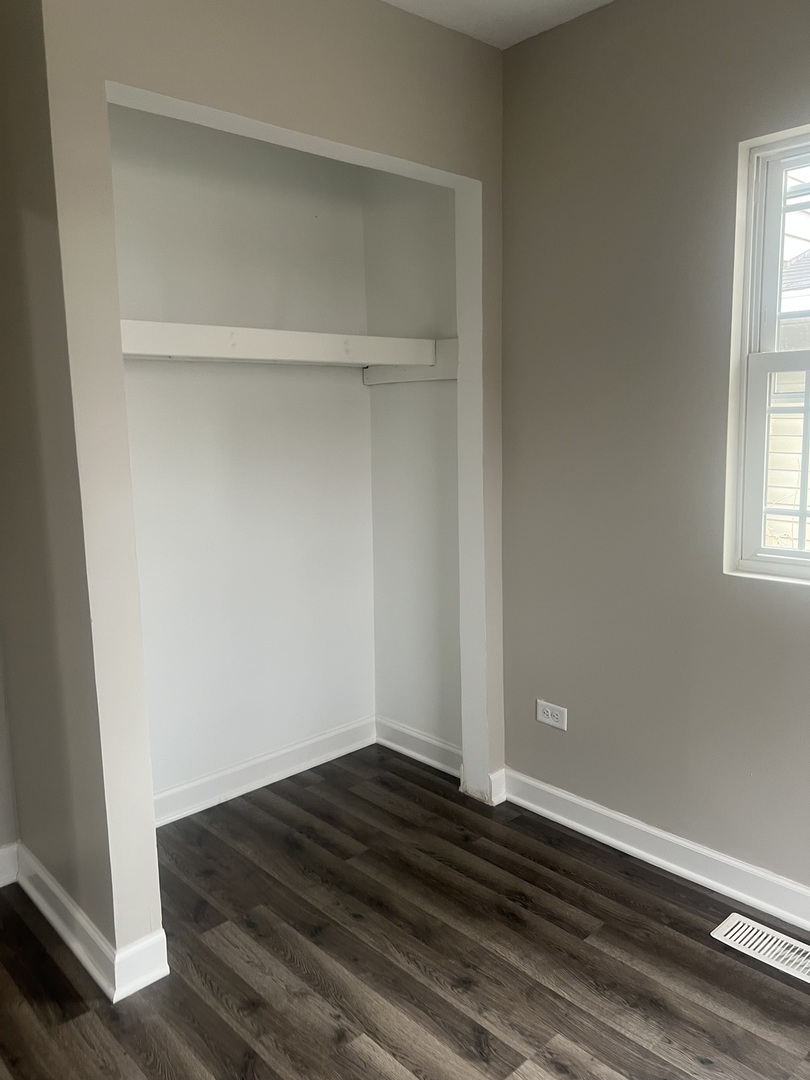 207 Davis Street Joliet, IL 60436 - Photo 10 of 23 a view of empty room with wooden floor and fan