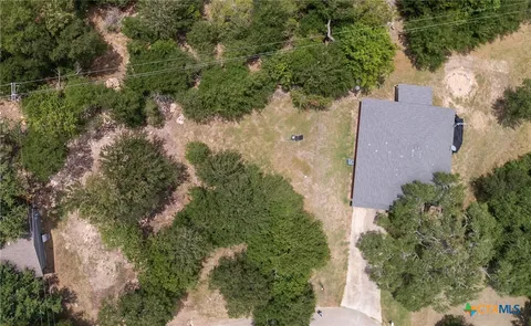 an aerial view of a house with yard