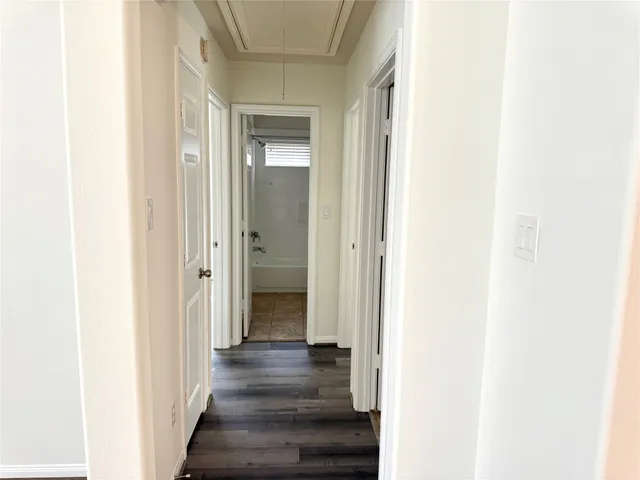a view of a hallway with wooden floor