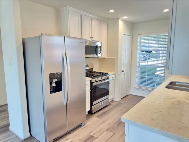 a kitchen with stainless steel appliances a refrigerator and a stove