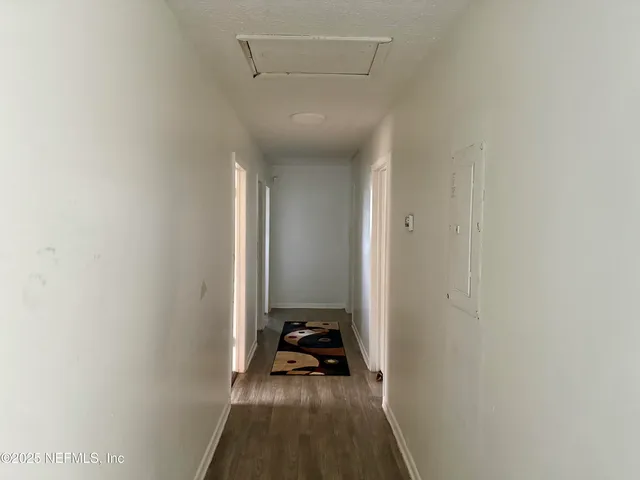 a view of a hallway with a room