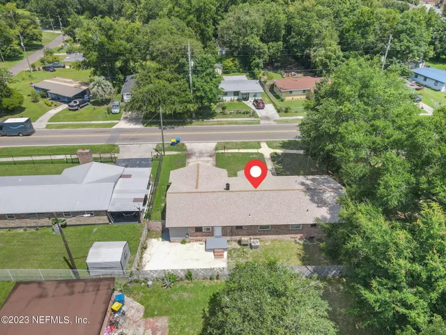 an aerial view of a house with garden space and street view