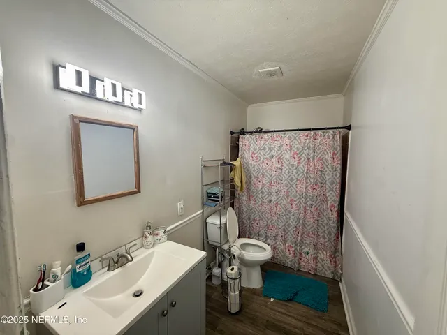 a bathroom with a sink toilet and shower